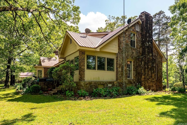 1494 N Miller Point Rd, Quitman, AR 72131 - view of side of home with stone siding, a yard, a chimney, and metal roof