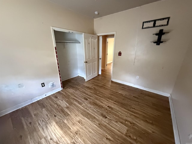 13506 Dynasty Dr, Alexander, AR 72002 - unfurnished bedroom featuring baseboards, a closet, and wood finished floors