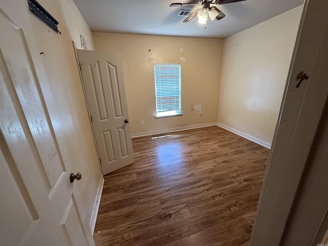 13506 Dynasty Dr, Alexander, AR 72002 - unfurnished bedroom with baseboards, dark wood finished floors, and visible vents