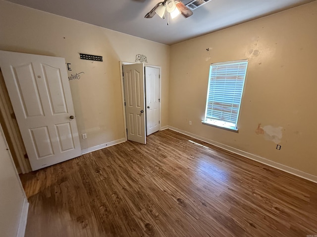 13506 Dynasty Dr, Alexander, AR 72002 - unfurnished bedroom with baseboards, visible vents, ceiling fan, and wood finished floors