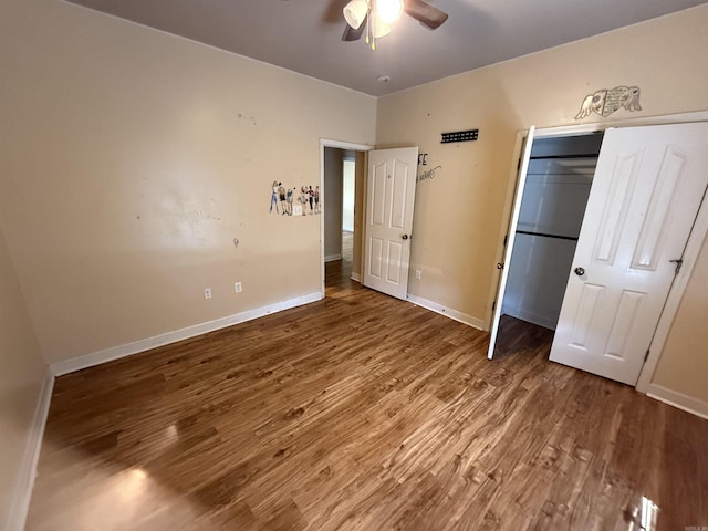 13506 Dynasty Dr, Alexander, AR 72002 - unfurnished bedroom with baseboards, a closet, a ceiling fan, and wood finished floors