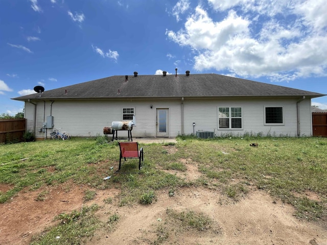 13506 Dynasty Dr, Alexander, AR 72002 - rear view of house with central air condition unit, fence, and a lawn