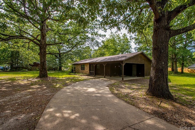 1400 S Rose St, Sheridan, AR 72150 - view of front of home featuring concrete driveway, a carport, and a front yard