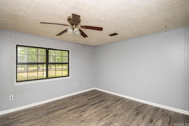1400 S Rose St, Sheridan, AR 72150 - unfurnished room with visible vents, wood finished floors, baseboards, and ceiling fan
