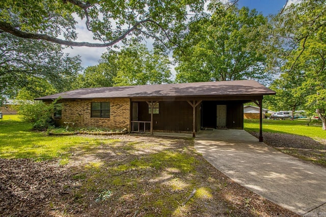 1400 S Rose St, Sheridan, AR 72150 - view of front of house with concrete driveway, a front yard, brick siding, and a carport