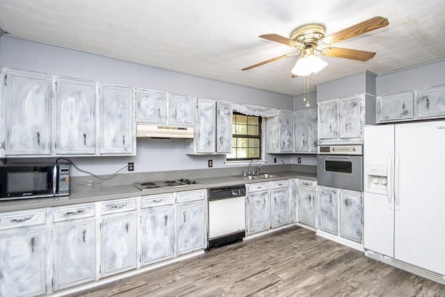 1400 S Rose St, Sheridan, AR 72150 - kitchen featuring wood finished floors, a sink, ceiling fan, white appliances, and under cabinet range hood