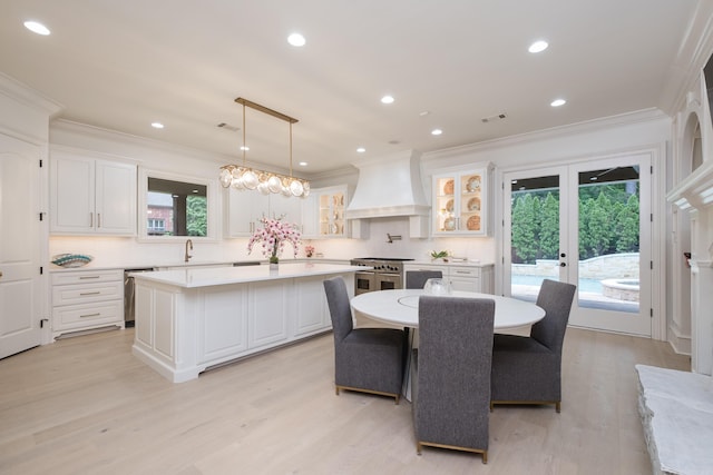 44 Deauville Cir, Little Rock, AR 72223 - kitchen with white cabinetry, light countertops, appliances with stainless steel finishes, a kitchen island, and custom exhaust hood