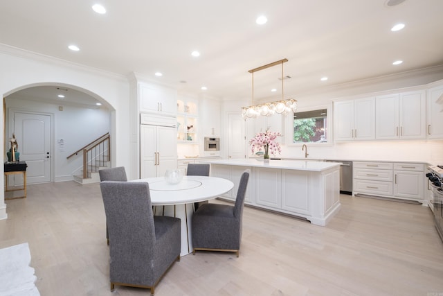44 Deauville Cir, Little Rock, AR 72223 - dining room with light wood-style flooring, recessed lighting, crown molding, arched walkways, and stairway