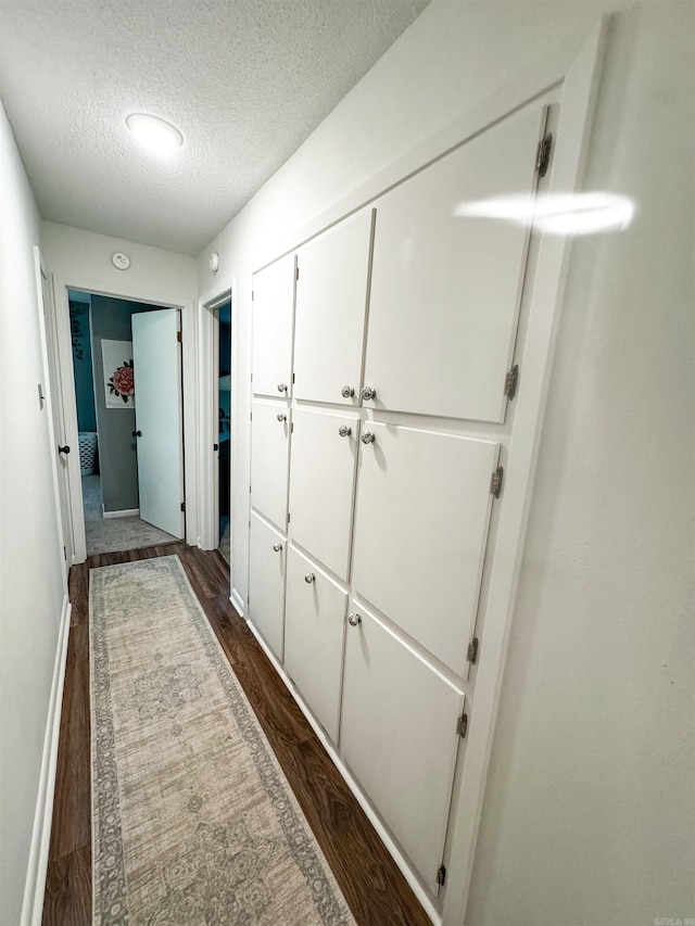 105 Liles, Searcy, AR 72143 - hall with a textured ceiling, baseboards, and dark wood-style floors