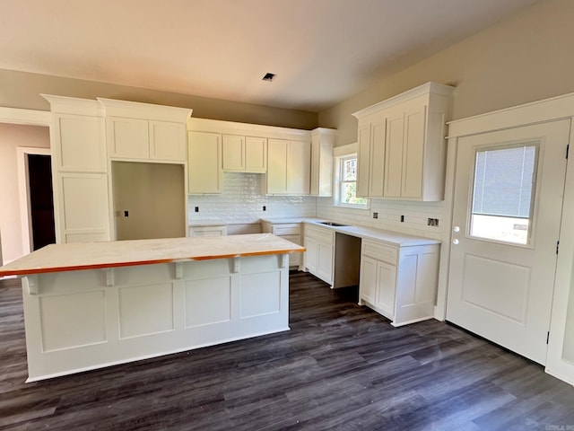 kitchen with white cabinetry, tasteful backsplash, and a kitchen island