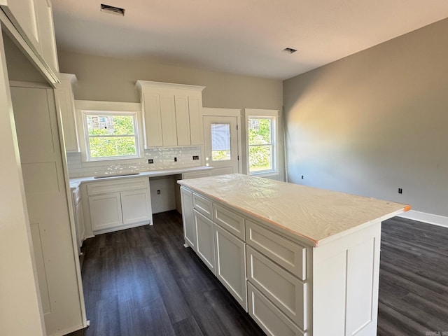 kitchen with backsplash, dark wood-style flooring, a healthy amount of sunlight, and visible vents