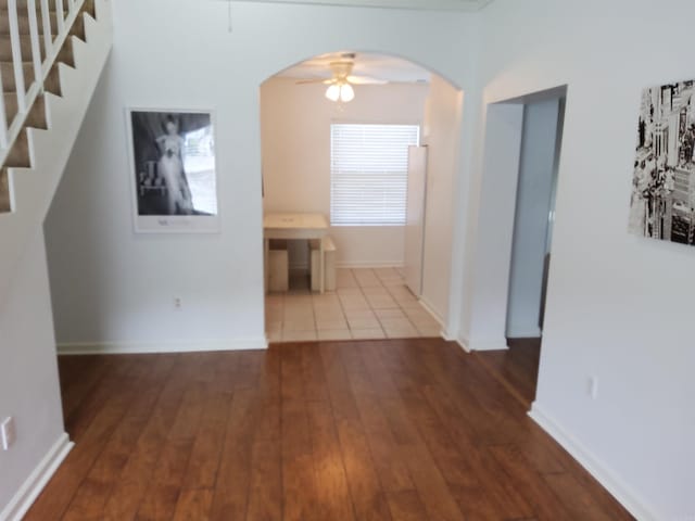 111 Prospect Ave, Hot Springs, AR 71901 - hallway featuring stairway, hardwood / wood-style flooring, arched walkways, and baseboards