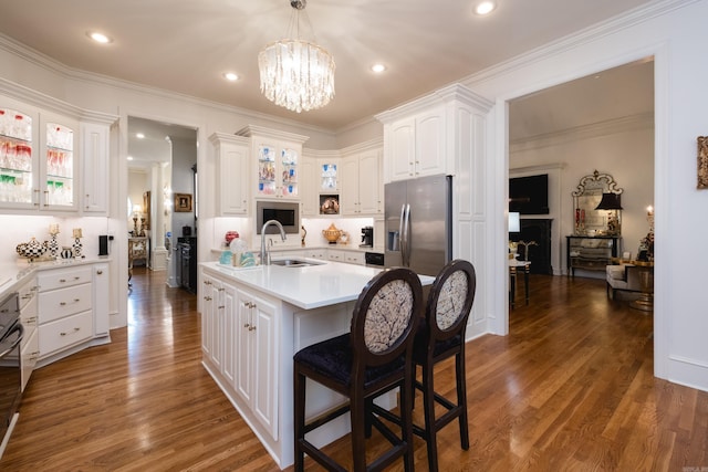 102 Falata Cir, Little Rock, AR 72223 - kitchen with a sink, stainless steel fridge, dark wood-style floors, glass insert cabinets, and white cabinets