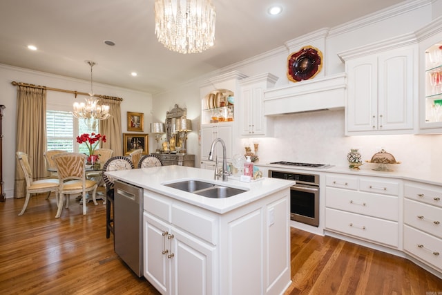 102 Falata Cir, Little Rock, AR 72223 - kitchen featuring appliances with stainless steel finishes, a sink, a chandelier, light countertops, and an island with sink