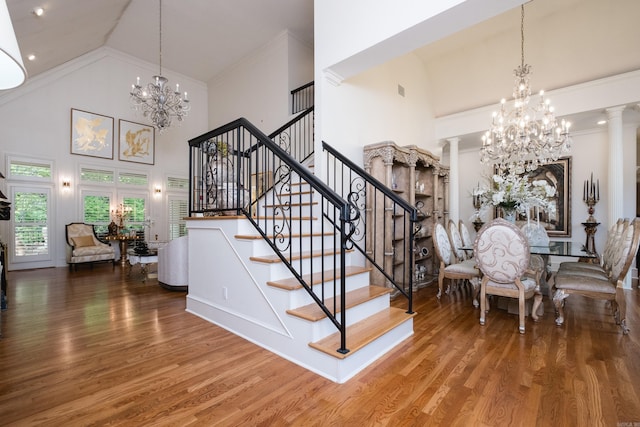 102 Falata Cir, Little Rock, AR 72223 - stairway with ornamental molding, an inviting chandelier, high vaulted ceiling, and wood finished floors