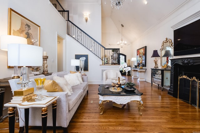 102 Falata Cir, Little Rock, AR 72223 - living room with wood finished floors, high vaulted ceiling, a notable chandelier, baseboards, and stairs