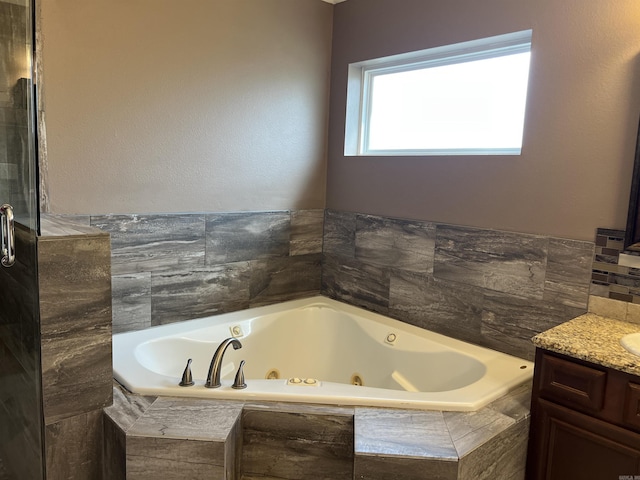 bathroom with a whirlpool tub and vanity