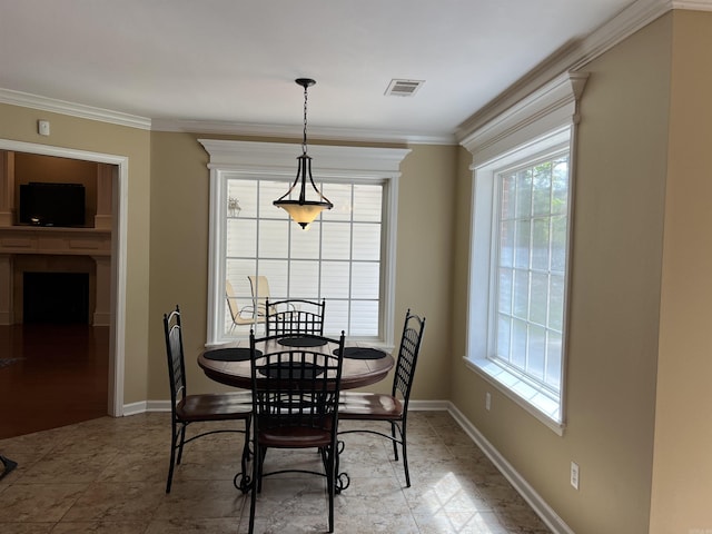 dining space with crown molding, visible vents, and baseboards