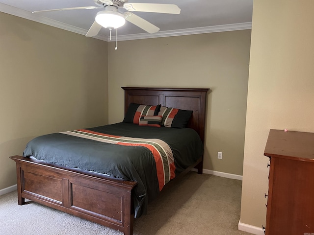 carpeted bedroom featuring ceiling fan, ornamental molding, and baseboards