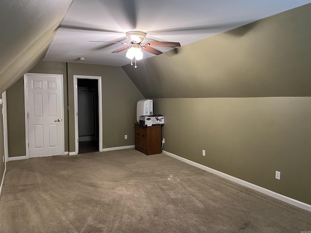 bonus room featuring lofted ceiling, carpet flooring, ceiling fan, and baseboards