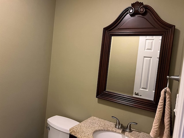 half bathroom featuring toilet and vanity