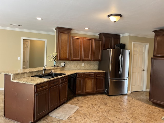 kitchen featuring freestanding refrigerator, dishwasher, visible vents, a sink, and a peninsula