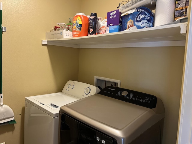 clothes washing area with laundry area and washer and dryer