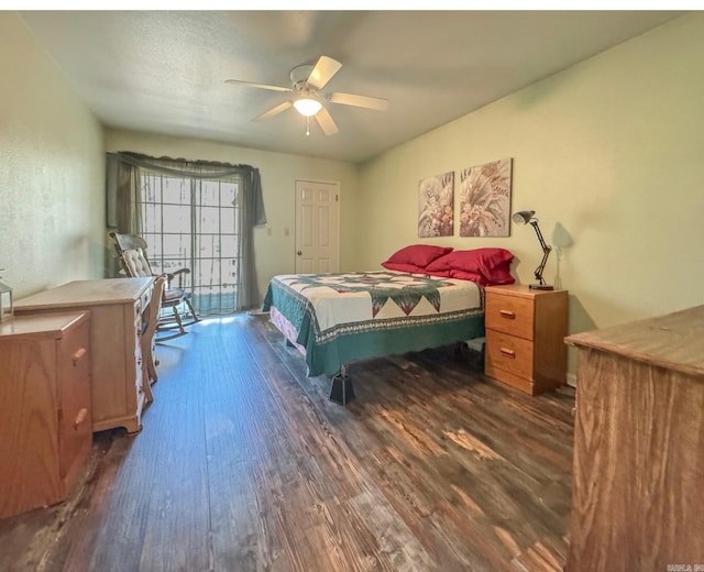 bedroom with a ceiling fan and dark wood-style flooring