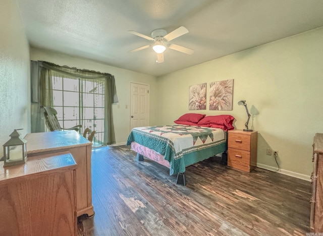 bedroom with baseboards, a ceiling fan, and dark wood-type flooring