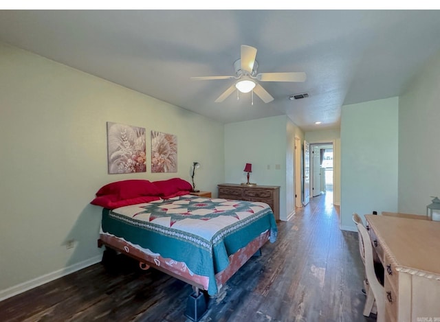 bedroom with visible vents, wood finished floors, baseboards, and ceiling fan
