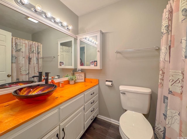 full bath with a shower with curtain, toilet, baseboards, vanity, and wood finished floors