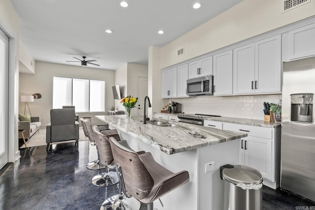 920 Park St, Little Rock, AR 72202 - kitchen featuring backsplash, visible vents, appliances with stainless steel finishes, and a sink