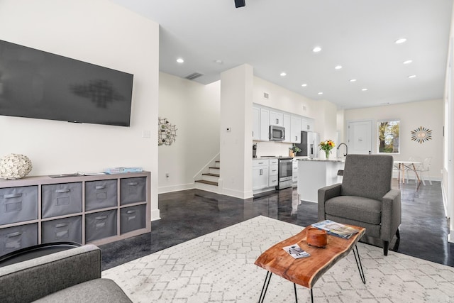 920 Park St, Little Rock, AR 72202 - living room with concrete floors, visible vents, baseboards, stairway, and recessed lighting