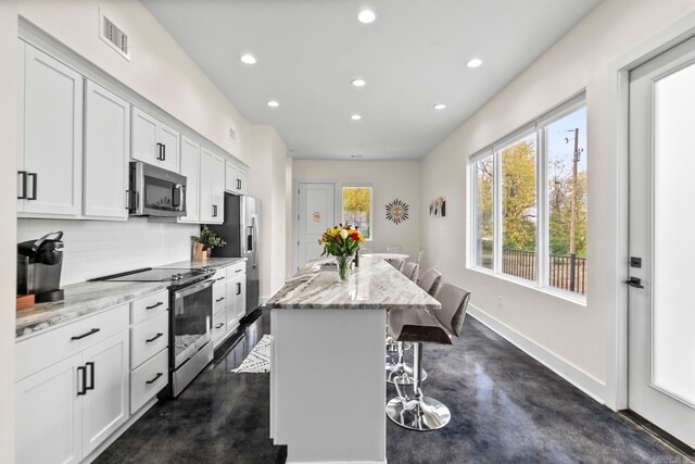 920 Park St, Little Rock, AR 72202 - kitchen featuring concrete floors, stainless steel appliances, recessed lighting, and a center island