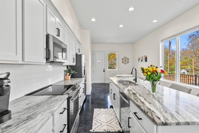 920 Park St, Little Rock, AR 72202 - kitchen featuring recessed lighting, a sink, decorative backsplash, a center island with sink, and appliances with stainless steel finishes