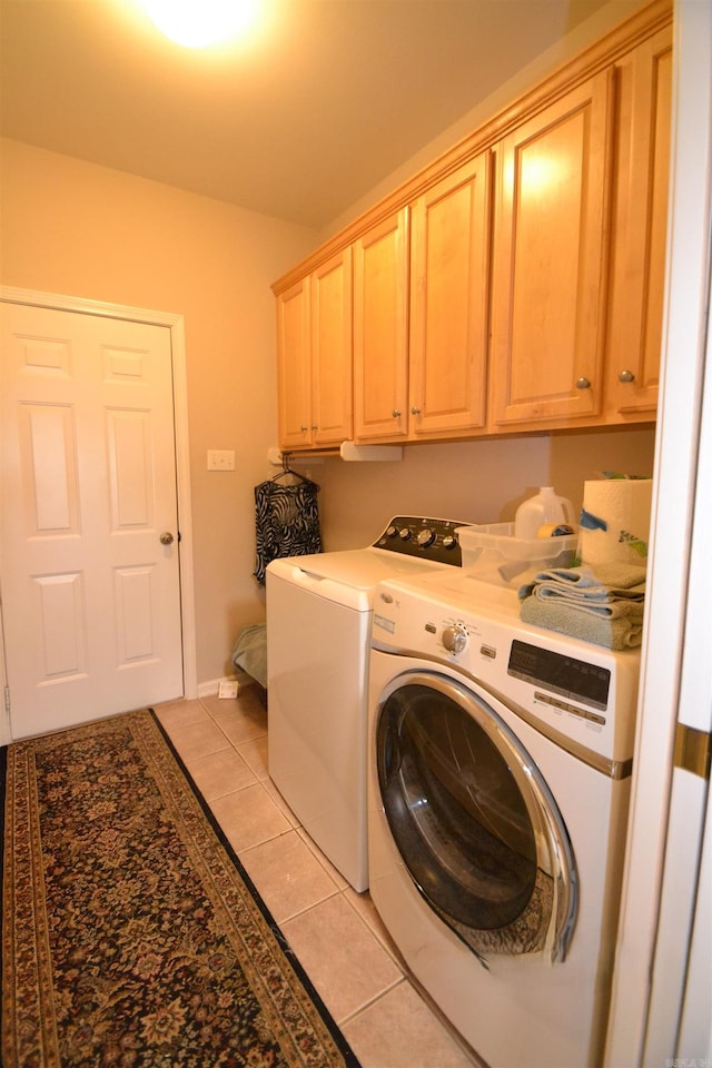 3810 Hanover Dr, Bryant, AR 72022 - laundry room featuring washing machine and clothes dryer, baseboards, light tile patterned floors, and cabinet space
