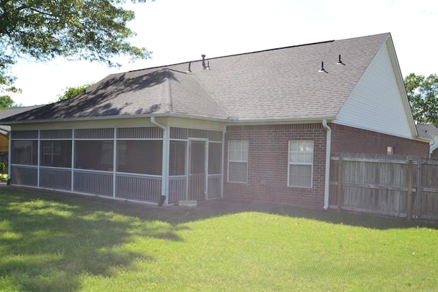 3810 Hanover Dr, Bryant, AR 72022 - rear view of house featuring a yard, brick siding, fence, a sunroom, and a shingled roof