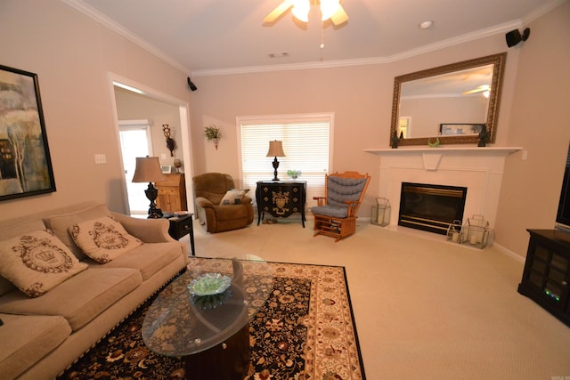 3810 Hanover Dr, Bryant, AR 72022 - carpeted living area featuring crown molding, a glass covered fireplace, a ceiling fan, and visible vents
