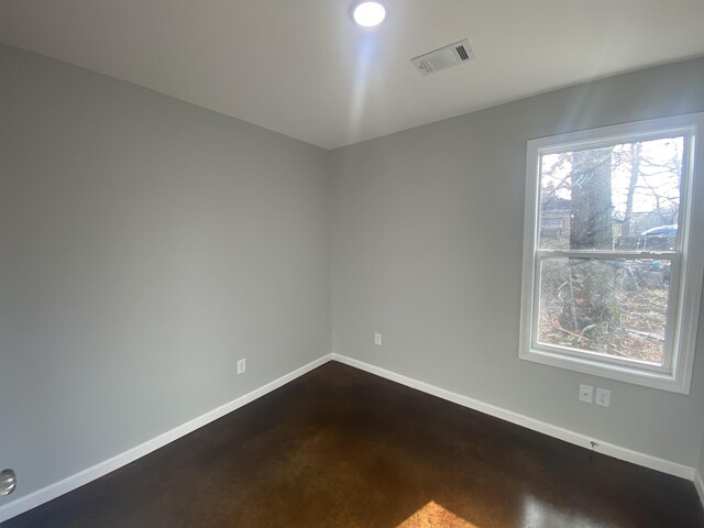 empty room featuring visible vents and baseboards