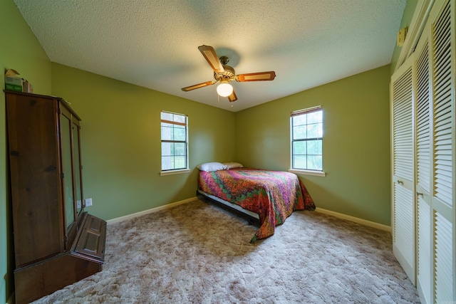 140 Bird Dove Ln, Heber Springs, AR 72543 - bedroom featuring a closet, carpet floors, a textured ceiling, baseboards, and ceiling fan