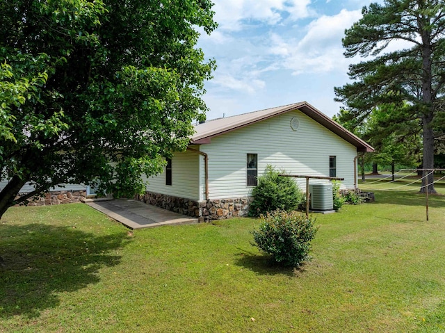 140 Bird Dove Ln, Heber Springs, AR 72543 - view of side of home featuring central AC unit, a yard, and stone siding