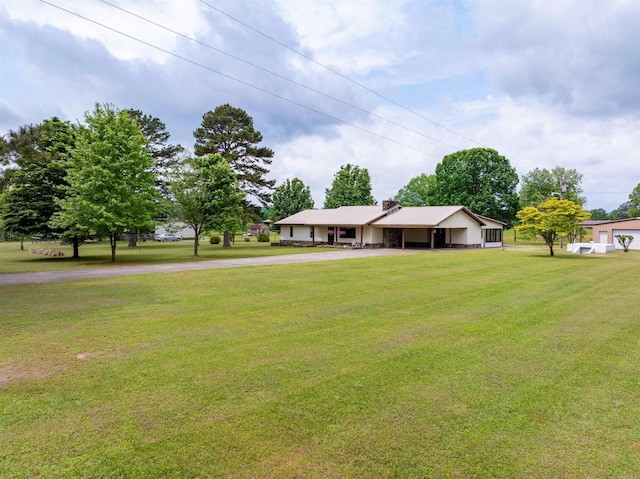 140 Bird Dove Ln, Heber Springs, AR 72543 - ranch-style home with a chimney, driveway, an attached garage, a front lawn, and a carport
