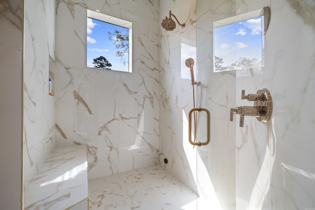 full bath featuring plenty of natural light and a marble finish shower