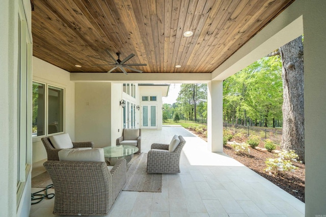 view of patio / terrace with fence, french doors, and a ceiling fan