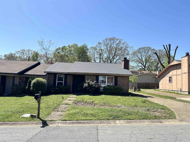 ranch-style home with a front lawn, brick siding, a chimney, and fence