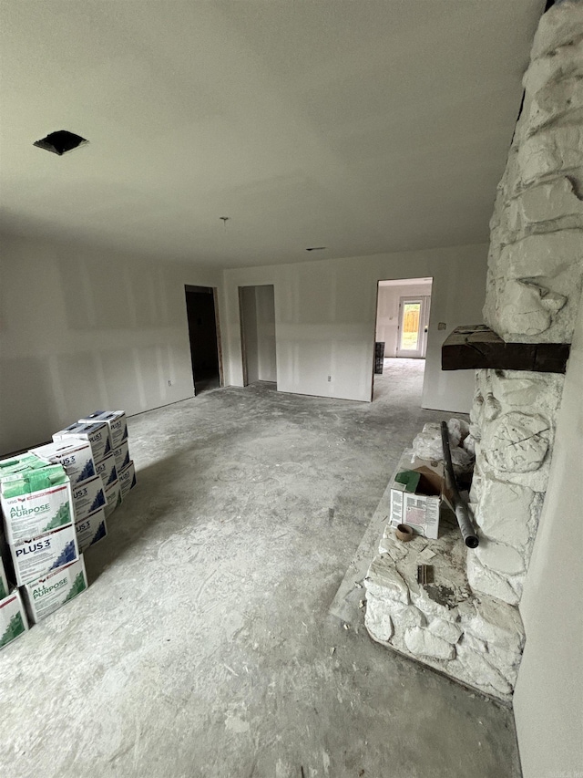 unfurnished living room with concrete flooring