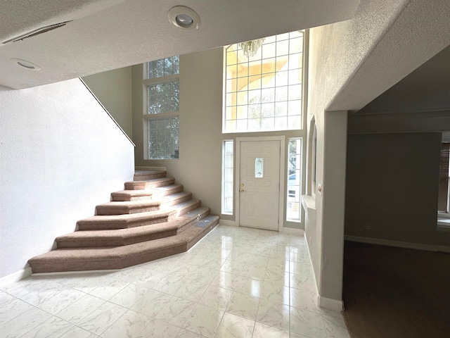 1906 Carolyn Dr, Jonesboro, AR 72404 - foyer featuring recessed lighting, a textured ceiling, baseboards, marble finish floor, and stairs