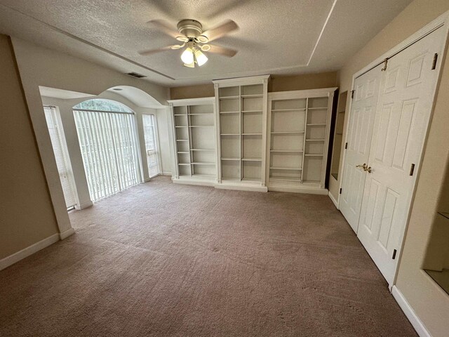 1906 Carolyn Dr, Jonesboro, AR 72404 - empty room with a ceiling fan, visible vents, a textured ceiling, and arched walkways