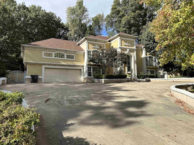 1906 Carolyn Dr, Jonesboro, AR 72404 - view of front facade with concrete driveway, stucco siding, a gate, and a garage