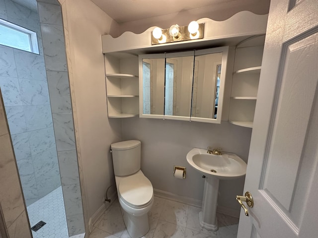 1906 Carolyn Dr, Jonesboro, AR 72404 - bathroom with toilet, baseboards, marble finish floor, and a tile shower